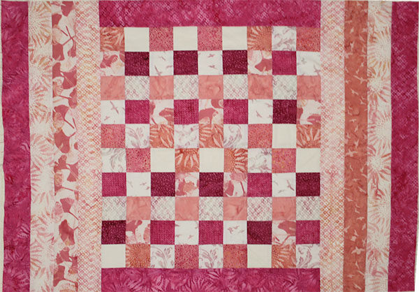 Pink and cream strips used to make baby size quilt.